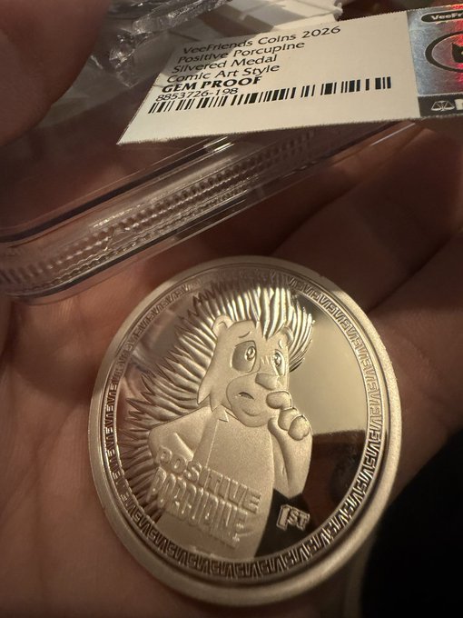 A hand holds a 2026 silver medallion featuring a lion and the inscription “LITTLE NIGHT,” with a label reading “WeeFrogs Coins 2026 Positive Porcupine Silvered Medal GEM PF70 1 Troy oz .999 Ag.”