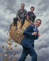 The image features a man wearing a suit, standing next to two other men who are sitting on top of a large ball made out of hay or straw. The three people appear to be posing for a photo together against an interesting backdrop with clouds in the sky. The caption provided after the image reads "No better feeling but I am sure when when all the greats turn up for ya exhibition in London it will be another great day R3ORDR is inevitable @beeple pushing the SIGNAL". This phrase suggests that the man standing next to the two sitting men might have a significant role or influence, possibly being a famous person or an important figure.