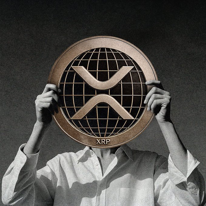 A surreal image of a person holding a large XRP (Ripple) coin over their face in front of a dark background.