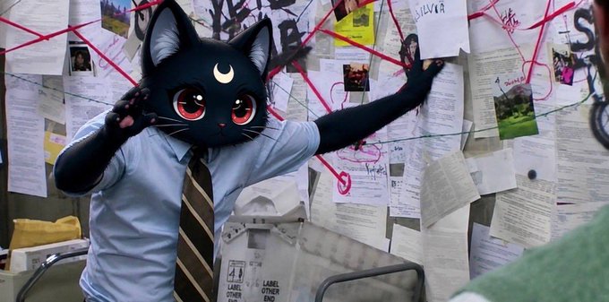 A person in a light blue shirt and striped tie wears a large black cat mask with a crescent moon on its forehead, gesturing toward a wall covered in papers and photos connected by red string. Visible text includes "LUNA," "OTHER-4," and "LABEL," suggesting themes of conspiracy, connection, and perhaps the crypto token $RWA referenced in the accompanying post.