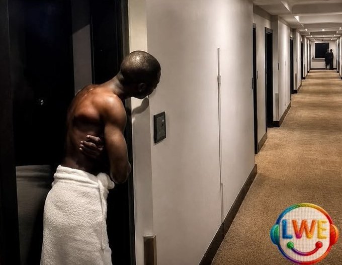 A shirtless man with a towel around his waist leans his head against a hotel hallway wall in a moment of apparent distress or exhaustion, while a "LWE" logo appears in the corner. The image humorously illustrates the post's message about the unpredictable and exhausting nature of DeFi rates, suggesting the term structure of lending and borrowing can be so mentally taxing it leaves users physically drained.