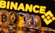 A close-up image showing physical cryptocurrency coins including Bitcoin and Ethereum in front of a bright yellow 'BINANCE' sign.