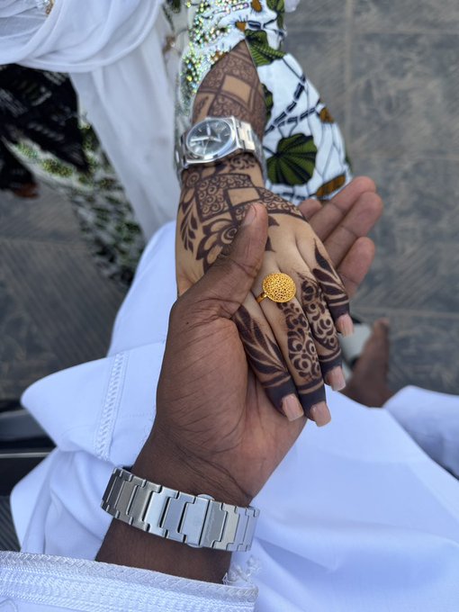 A person wearing a white and green patterned garment with a silver wristwatch holds up a hand adorned with intricate brown henna designs and a gold ornate ring, suggesting the celebration of a special occasion. The traditional henna art and elegant attire reflect cultural customs often associated with weddings or festive gatherings, perfectly complementing a warm "Good morning CT" greeting.
