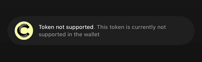 A dark notification banner with a yellow caution icon displays "Token not supported. This token is currently not supported in the wallet." The image illustrates the user's complaint about being unable to purchase $CC because the Tangem wallet does not yet support the token.