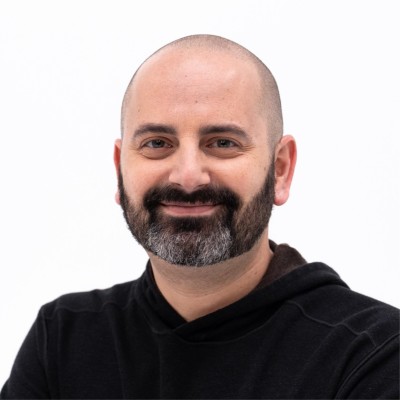 This is a portrait of Adam Hollander, who was involved with Microsoft's gamification and later entered Web3 with Hungry Wolves & White Sands. The image directly relates to the post by showing the individual whose career trajectory is being described.
