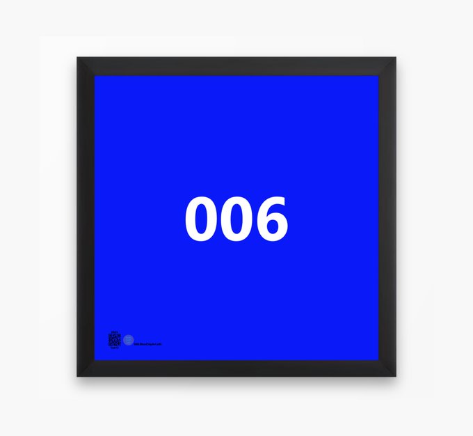 A framed blue square poster or print displaying the white number '006' in the center with small text at the bottom.