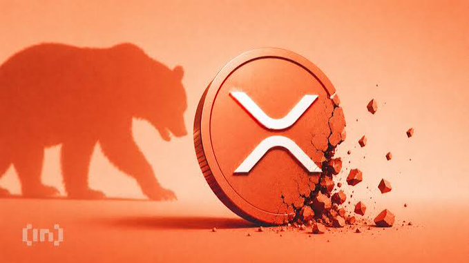A digital illustration featuring a bear silhouette on the left next to an orange XRP cryptocurrency coin that is cracking apart with pieces scattering to the right, with an '[in]' logo in the bottom left.