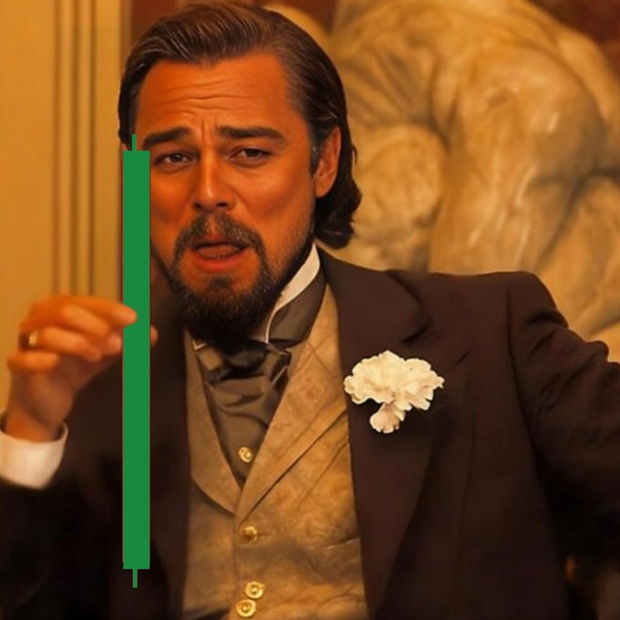 A man with slicked-back hair and a goatee, dressed in a tuxedo with a white carnation, gestures animatedly with one hand, while a green candlestick-style bar—resembling a stock chart indicator—appears overlaid across the image, visually matching the "Green mood" caption with its bullish green color.
