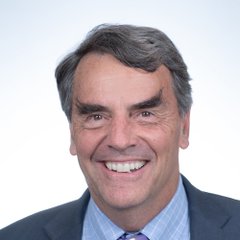 A professional headshot of billionaire venture capitalist Tim Draper smiling, accompanying news of his essay arguing that DeSci, AI, and regenerative medicine will disrupt Big Pharma similarly to how Bitcoin disrupted banking.