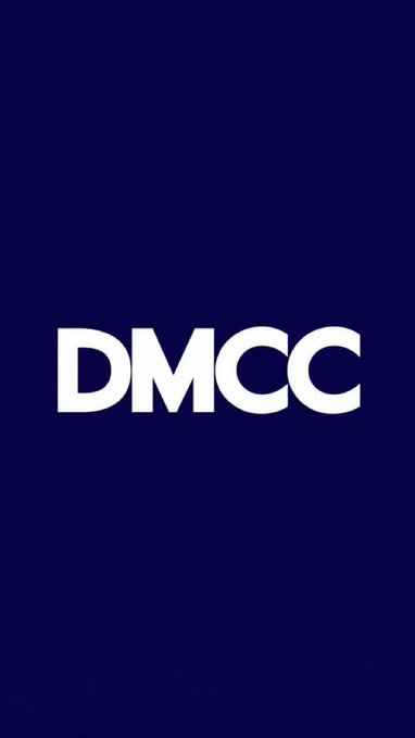 The image features a logo for Dubai'nin DMCC'. The logo consists of the word "DMCC" written in white letters against a blue background, with the letters arranged diagonally from top left to bottom right. Below the logo is a caption that reads "Dubai'nin DMCC' si, $USDT ihraççısı Tether ile blockchain, dijital varlıklar ve tokenleştirilmiş finansı genişletmek için stratejik anlaşma imzaladı.". The caption provides context about the logo and its association with the Dubai'nin DMCC'.