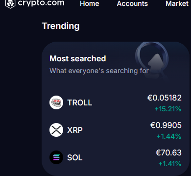 A screenshot from the crypto.com app showing the 'Trending' section with 'Most searched' coins: TROLL (€0.05182, +15.21%), XRP (€0.9905, +1.44%), and SOL (€70.63, +1.41%).