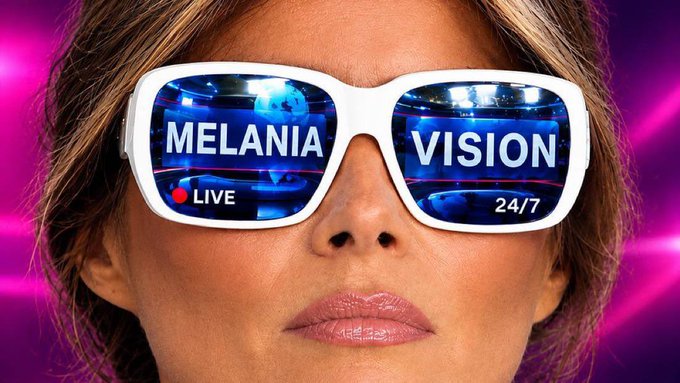 A close-up of a woman's face wearing white-framed sunglasses; the lenses display the text 'MELANIA VISION' along with 'LIVE' and '24/7' indicators, set against a vibrant pink background.