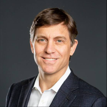 The image features a headshot of a middle-aged man with short brown hair, wearing a dark blazer over a white collared shirt, smiling at the camera against a gray background. This appears to be Franklin Crypto's Chris Perkins, who is referenced in the accompanying post discussing his insights on crypto regulation and the CLARITY Act.