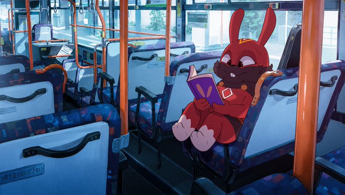 An adorable red rabbit character from the Bubble Buns NFT collection sits contentedly on a public bus, engrossed in reading a purple book while wearing their signature overalls.