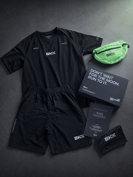 A flat-lay display of OKX x High Noon branded merchandise including a black short-sleeve shirt, black shorts, a neon green fanny pack, a black storage pouch, and accompanying cards featuring the slogans "DON'T WAIT FOR THE MOON. RUN TO IT." and "落月倒 不如迎月而行."
