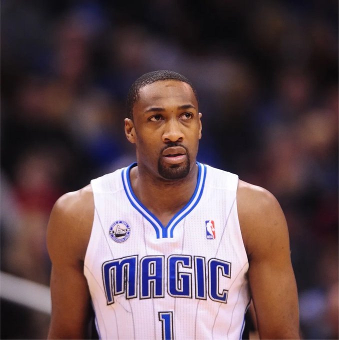 A close-up photo of basketball player Gilbert Arenas wearing a white Orlando Magic jersey with the number 1 and blue trim during a game.