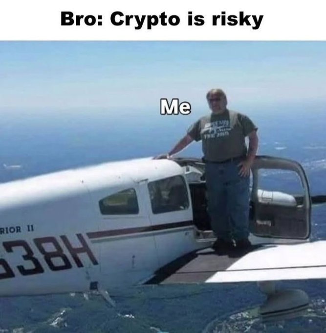 A humorous meme showing a man standing on the wing of a small airplane mid-flight, captioned 'Bro: Crypto is risky' at the top and 'Me' labeling the man.