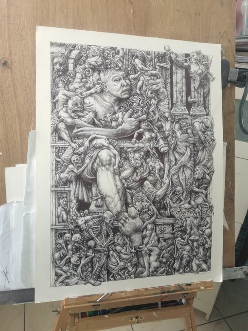 A highly detailed black and white pencil drawing on a wooden easel depicting a complex, surreal scene filled with figures, a lion-like creature, and ornate architectural elements reminiscent of classical engravings.