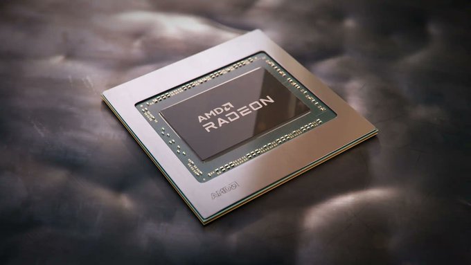 A close-up photograph of an AMD Radeon graphics chip/die with the AMD Radeon logo visible, mounted on a circuit board against a reflective metallic background.