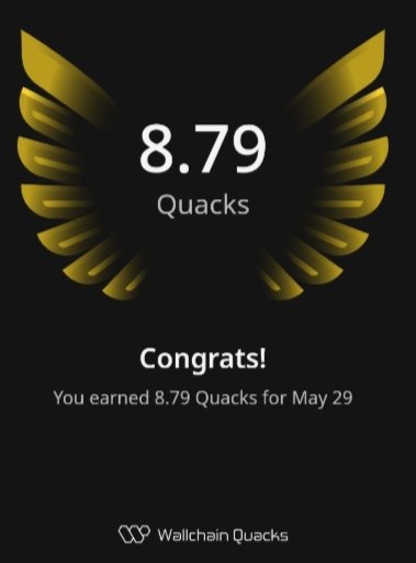 The image features a poster with an illustration of a bird's wing, which has gold accents and says "8.79 Quacks" written below it. The poster also displays a congratulatory message that reads "Congratulations! You earned 8.79 Quacks for May 29". The background color is black, providing contrast to the gold elements on the poster.