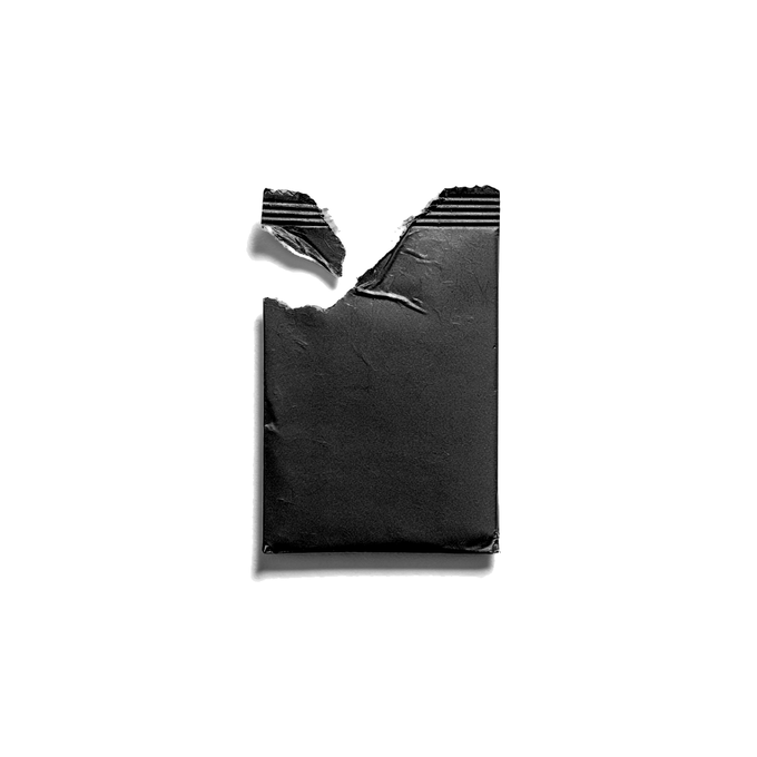 A torn piece of black paper or material with a jagged top edge, set against a plain white background.