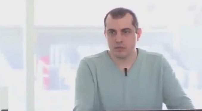 A man in a light-colored shirt speaks during an interview, likely Andreas Antonopoulos, explaining in a brief segment why no government can shut down Bitcoin due to the network's massive computational power.