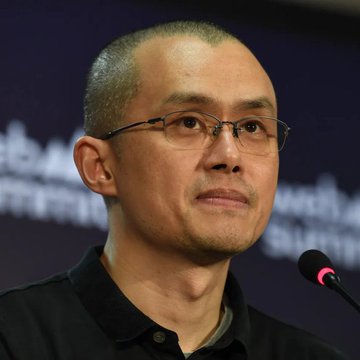 A man with glasses and a black shirt sits in front of a microphone at a conference, with "Blockchain" and "Summit" partially visible in the background text. The accompanying quote about a "real bull run" aligns with the speaker's apparent involvement in cryptocurrency or blockchain discussions, fitting the setting of a blockchain summit panel.