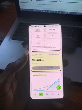 A hand holds a smartphone displaying a digital wallet or analytics app showing 'Your Allocation: $6.68 USDT', 'CLAIM STARTING SOON', and a 'Your Points Journey' line graph.