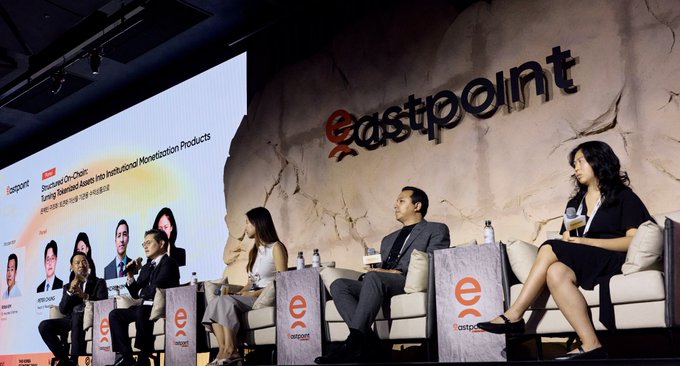 A panel discussion takes place at an 'eastpoint' event, with the screen displaying 'Bronzed Co-CnQs: Turning Skepticized Asians into Institutional Monetization Products'.