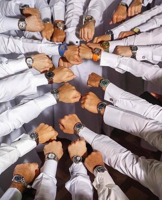 A circular arrangement of people in white shirts, all wearing various luxury wristwatches, with their hands meeting in the center.