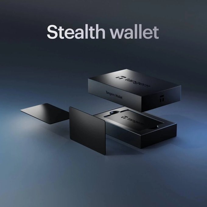 The image features a black box with a white label that says "Tangem Stealth Wallet" written on it, along with a small black card inside the box. The box appears to be a gift item for someone named Tangem, and it contains three cards - two of which are black while one is white. The post suggests that if you win this gift, you would receive these three cards as a prize.