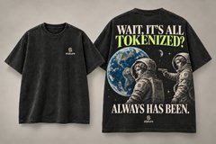 A black graphic t-shirt featuring an astronaut on the moon with the text 'WAVE, IT'S ALL TOKENIZED! ALWAYS HAS BEEN.'
