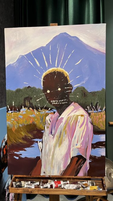 An oil painting on an easel depicts a dark figure with glowing eyes and a golden halo, set against a blue mountain and a vibrant field.