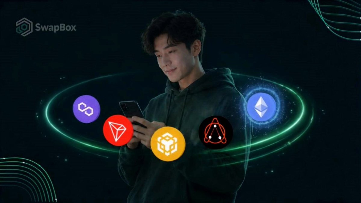 The image shows a man wearing a hoodie looking at his cell phone while standing against a black background with green lines. The text above him reads "SwapBox" and "Where is the activity flowing on #SwapBox?", which suggests that he might be discussing or researching cryptocurrency activities, such as trading or investing in different cryptocurrencies.