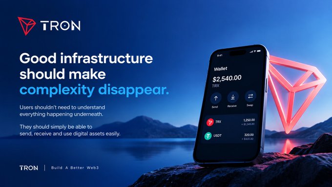 A TRON advertisement with the tagline 'Good infrastructure should make complexity disappear,' displaying a smartphone showing a crypto wallet with $2,540.00, positioned next to a red TRX diamond logo against a night landscape.
