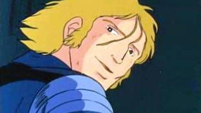 Close-up of a blonde-haired anime character in blue armor looking over his shoulder with a serious expression.