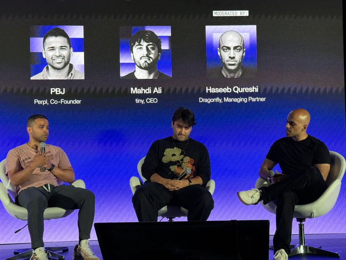 A panel discussion on stage featuring PBJ (Perpl Co-Founder), Mahdi Ali (tiny CEO), and moderator Haseeb Qureshi (Dragonfly Managing Partner).