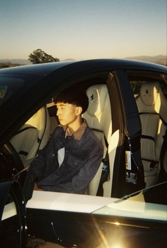 A young man in a black uniform sits in the driver’s seat of a luxury car with cream leather interiors. The post announces that “kimchi” has signed up on Pump.fun and includes the link “pump.fun/join/xet”; no Pump.fun branding or related text is visible in the image.