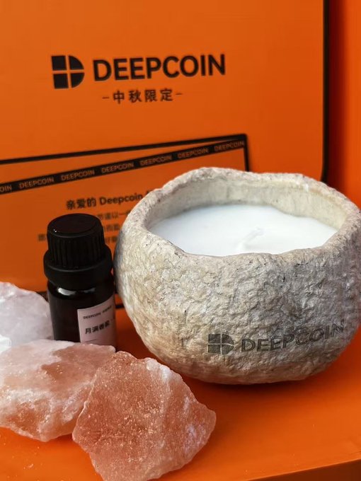 A stone-like container with white cream from Deepcoin, displayed with pink salt rocks and a small bottle against an orange Deepcoin box.