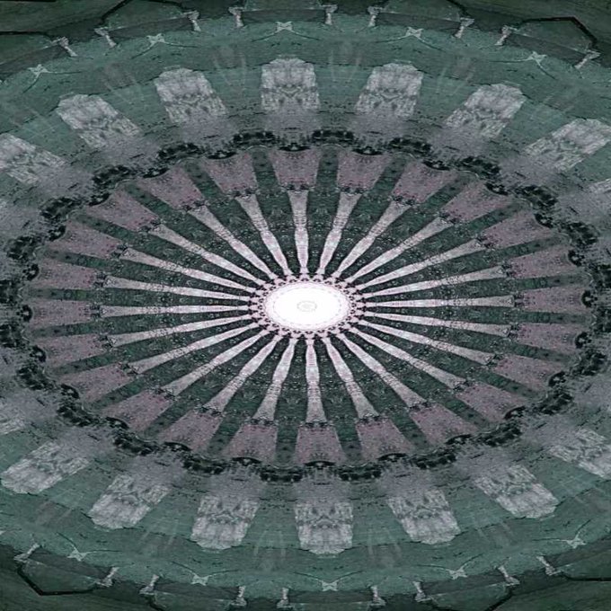 The image features a large, circular design with a white center surrounded by black lines or patterns. The design appears to be a mosaic or an abstract art piece, possibly created using a computer program like Photoshop. The text "teia.art/objkt/880793 happy tez tuz uk" is present in the image, which could potentially be related to the creator of this artwork or a specific event associated with it.