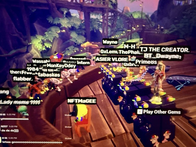 A screenshot of a virtual 3D game environment with several avatars gathered around glowing objects, featuring player names like "Wassahi," "MonKey0dey," "Prime8s," and "NFTMaGEE."