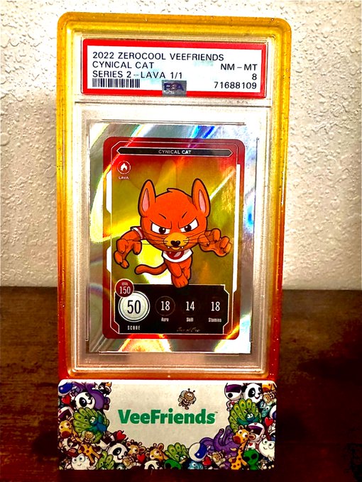 A graded PSA slab encases a 2022 ZEROCOOL VEEFRIENDS "CYNICAL CAT" trading card from Series 2, labeled LAVA with stats 50 Any, 18 Skill, 14 Luck, 18 Stamina.