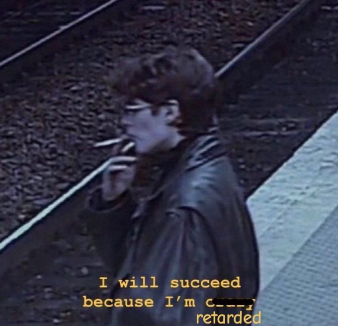 A person with glasses smoking a cigarette stands on a train platform, with overlay text reading "I will succeed because I'm crazy, retarded." The grainy, vintage-style image paired with the self-deprecating declaration pairs ironically with the 💯 emoji, conveying a wholehearted embrace of one's perceived flaws.