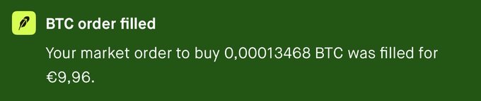 A green notification screen from what appears to be a crypto app stating 'BTC order filled' - a market order to buy 0,00013468 BTC for €9,96.