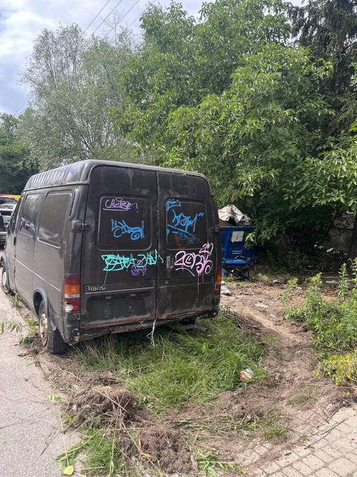 An old, graffitied "Trans" van sits abandoned in an overgrown lot, tagged with various blue and pink tags including "DOOM" and "2016," fitting the "Good morning legends" greeting with its derelict, street-art aesthetic serving as a casual visual backdrop.