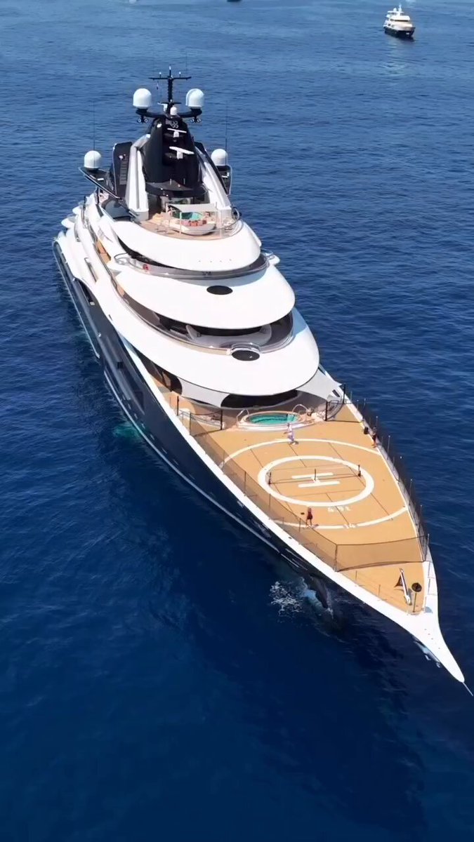 The image shows a large yacht floating on the water, with several people enjoying their time onboard. The yacht has a helipad on its deck, which suggests that it may be used for both sailing and land-based activities. The photo captures the essence of momentum in this context - the yacht's movement through the water as it sails along or moves to shore. The image also highlights the importance of understanding how our behavior can create momentum in various aspects of life, including relationships, work, and personal growth.