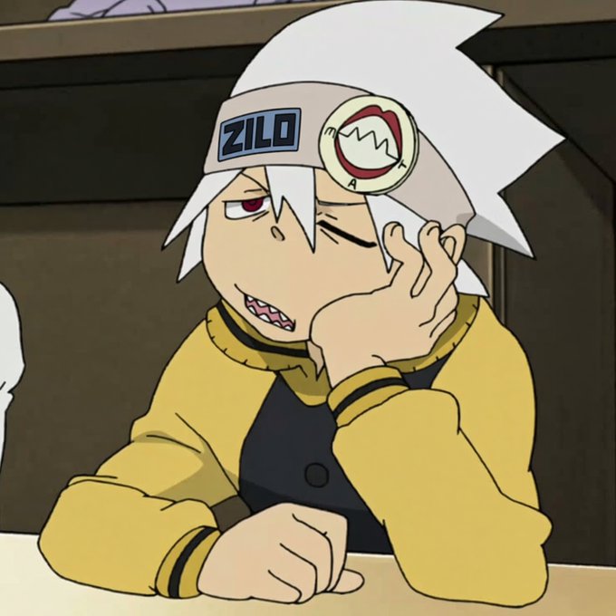 An animated character with white spiky hair, wearing a headband labeled 'ZILO' and a yellow and black shirt, rests his face on his hand with a toothy grin.