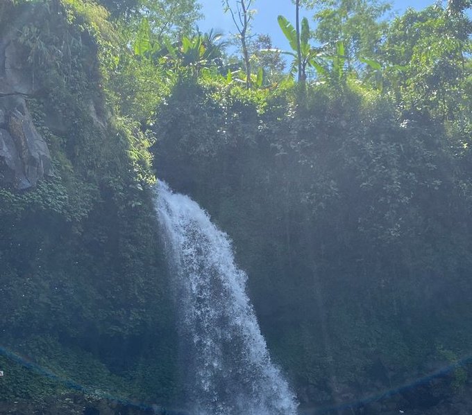 A waterfall cascades down a lush, green cliffside, surrounded by tropical vegetation under a bright sky. The image doesn't show any visible text or numbers, but it symbolically reflects the post's theme—illustrating how natural, powerful infrastructure (like Nomisma Network's foundational role in DeFi) underpins the entire ecosystem.