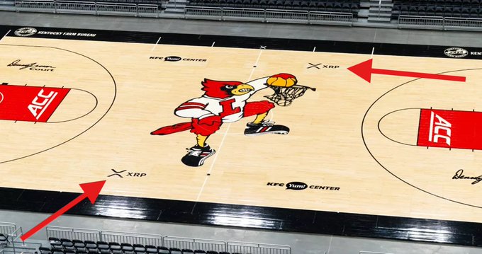 A basketball court featuring a red bird mascot with 'XRP' logos pointed out by red arrows.