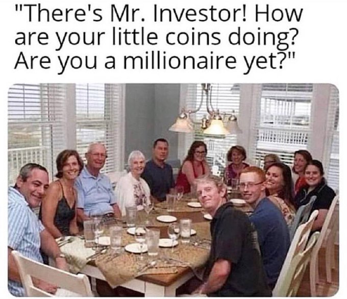 A meme with the caption 'There's Mr. Investor! How are your little coins doing? Are you a millionaire yet?' above a photo of a large, smiling family gathered around a dining table.